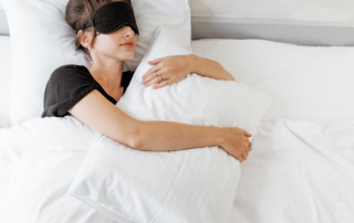 Woman holding pillow while resting.