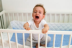 infant sleep apnea - baby crying in crip