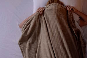 REM sleep behavior disorder - woman under covers