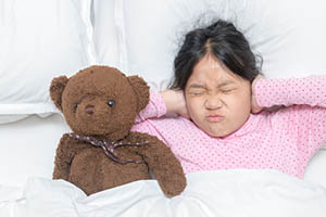 sleep hallucinations - girl in bed with teddy bear