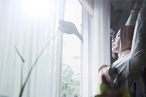 bright light therapy - woman looking out window