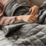 Weighted blanket on woman in bed