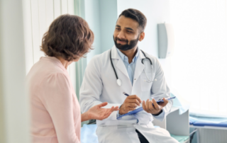 Doctor talking to patient in office
